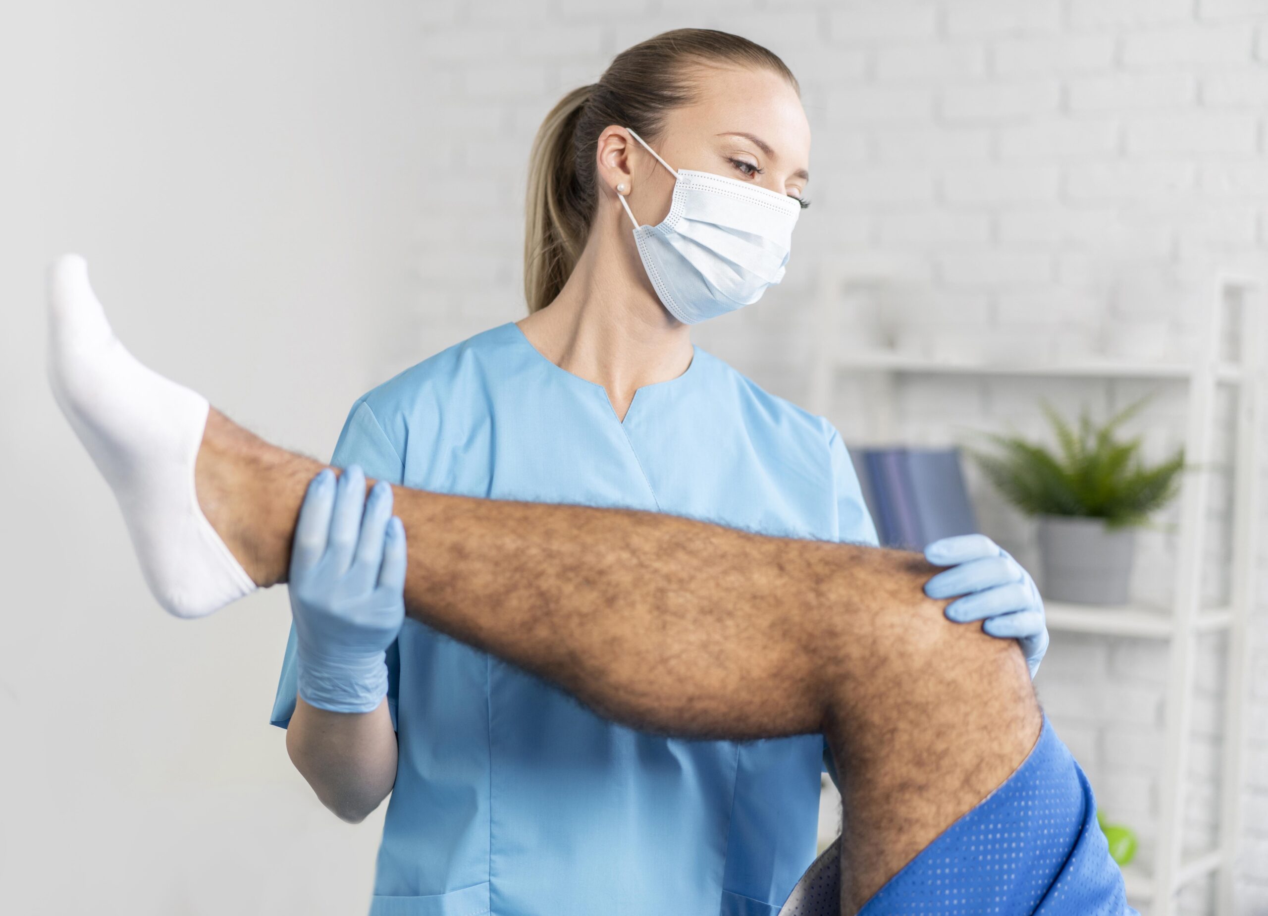 female-physiotherapist-with-man-s-leg