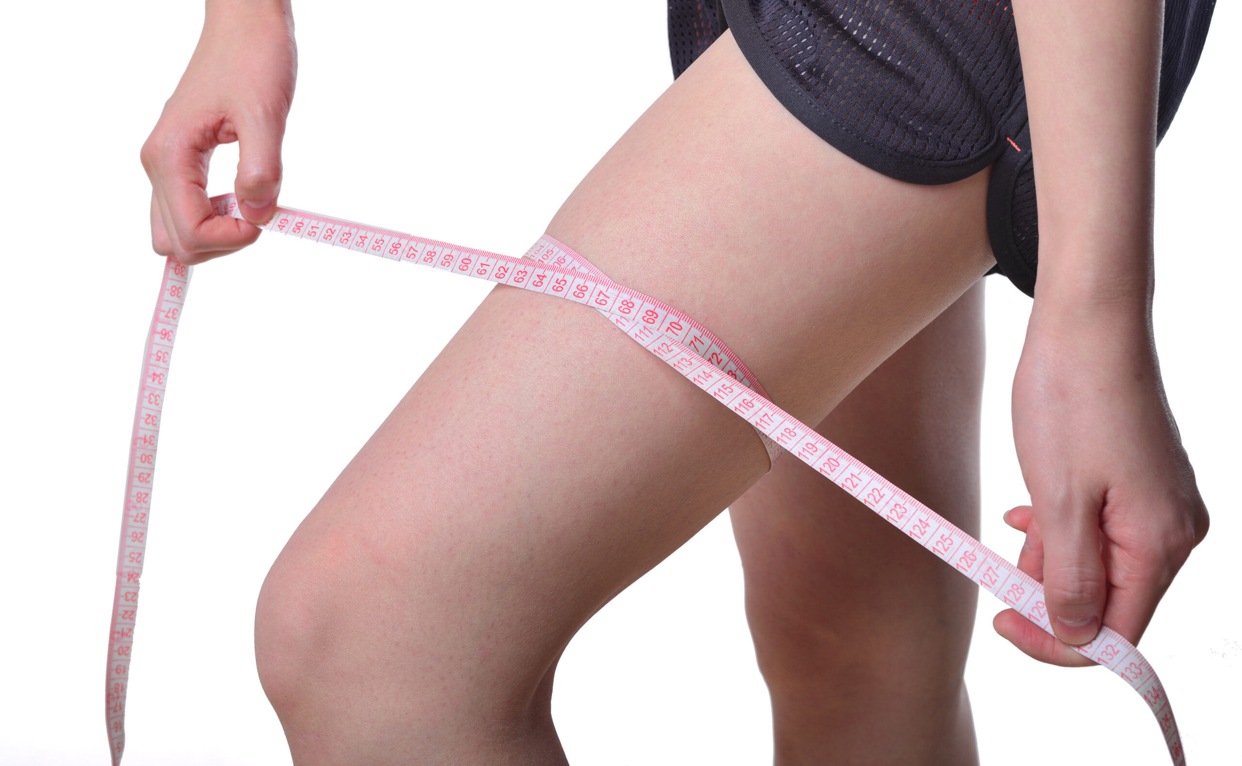 perfect womans legs measure by metre-stick over white