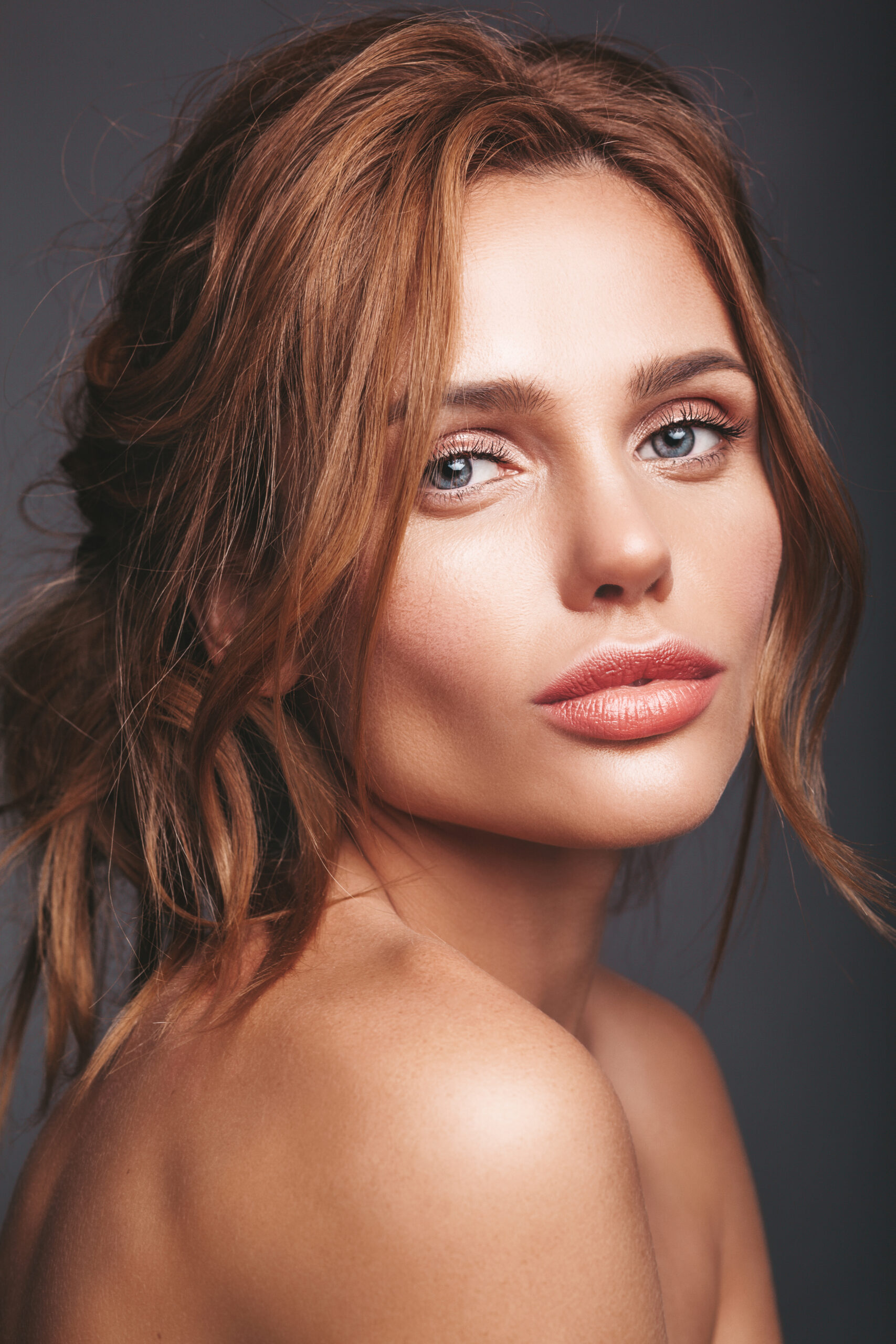 Beauty fashion portrait of young blond woman model with natural makeup and perfect skin posing in studio