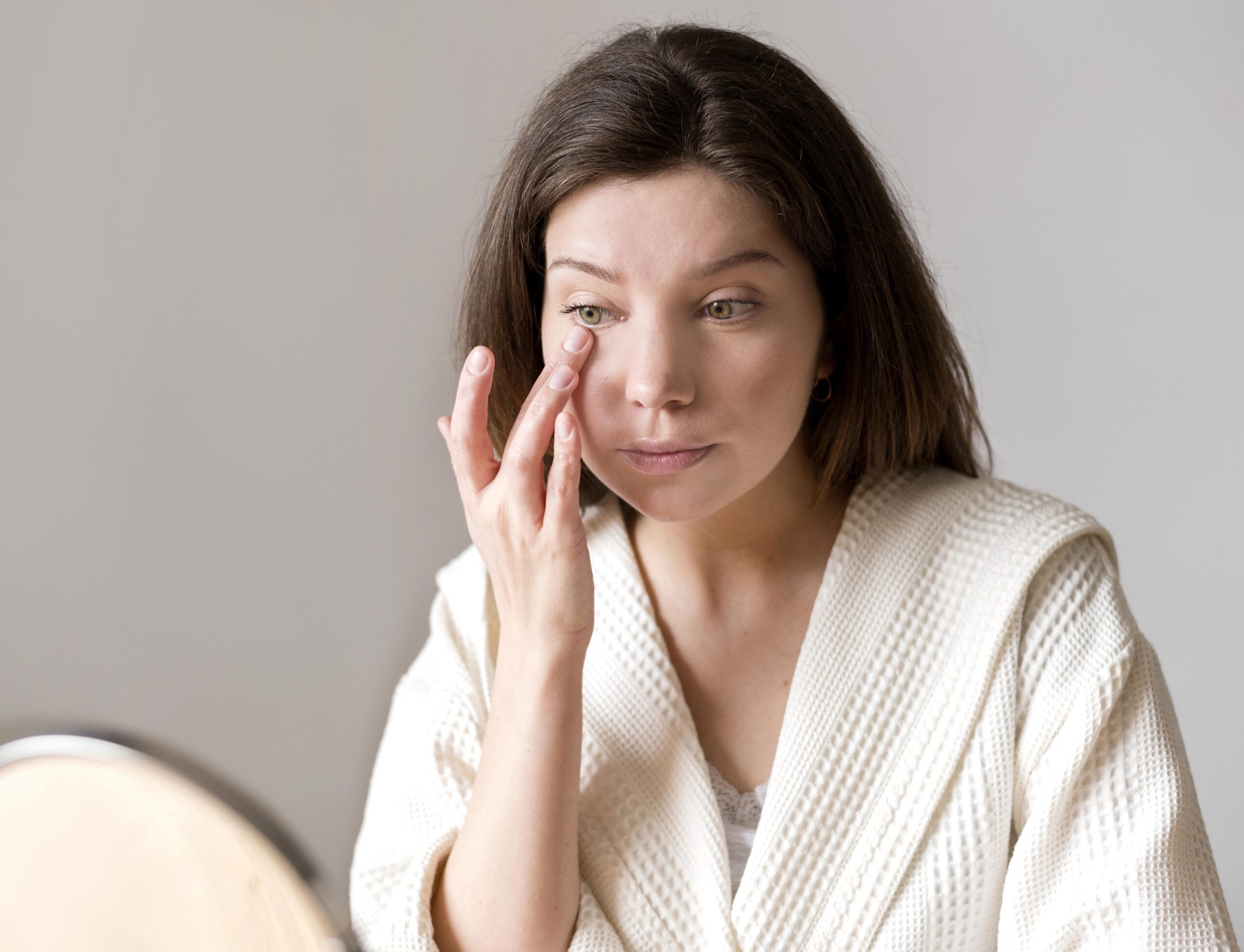 female-applying-eye-concelear-with-hand